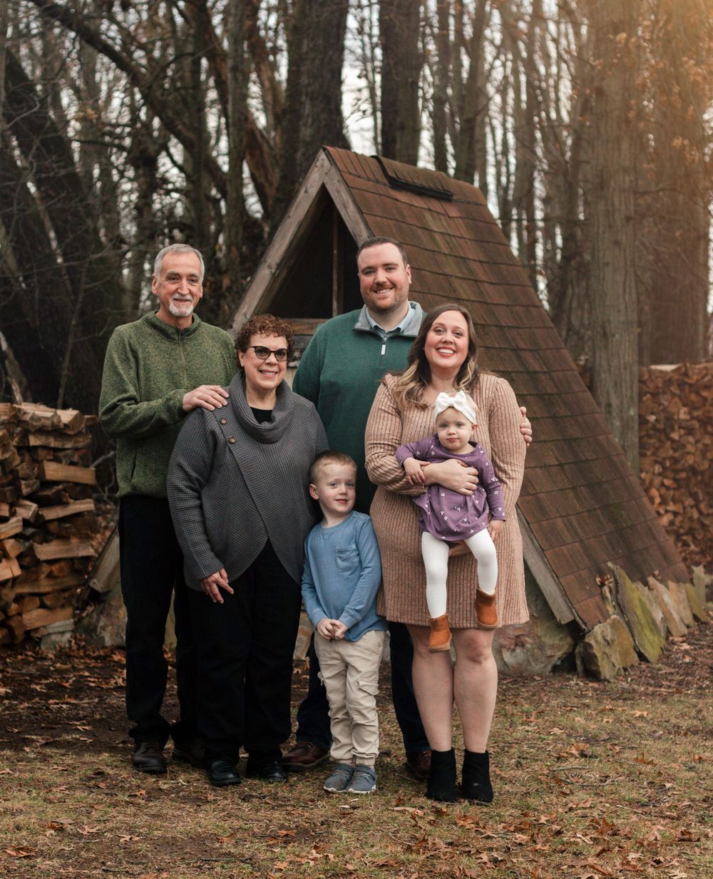 Natural light Christmas portraits focused on authentic family connection. Outdoor holiday family photos taken in a snowy park setting. Holid