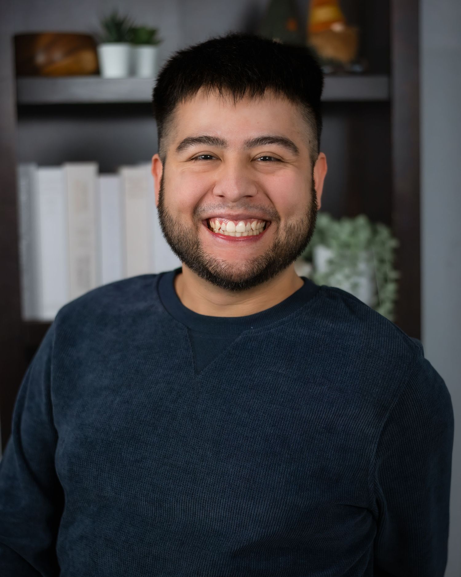A multi-photo collage showing someone in a dark colored shirt smiling warmly against a soft-focus background.