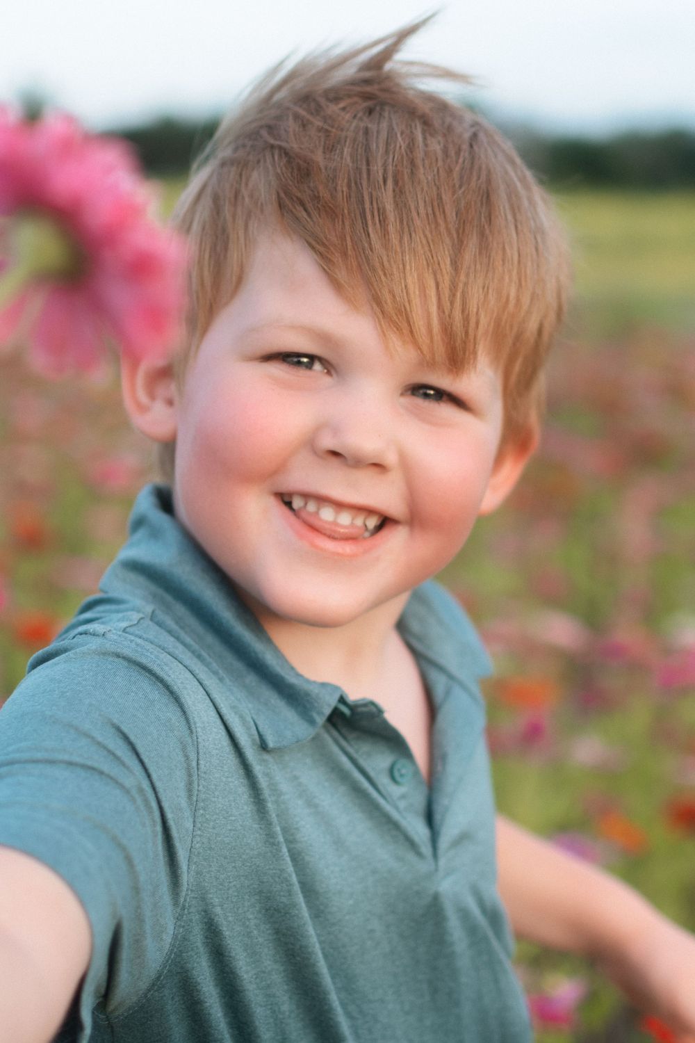 Portrait of a red-haired boy in spring flower fields at Fancy Farms Market, Plant City, Florida by a Florida photographer.