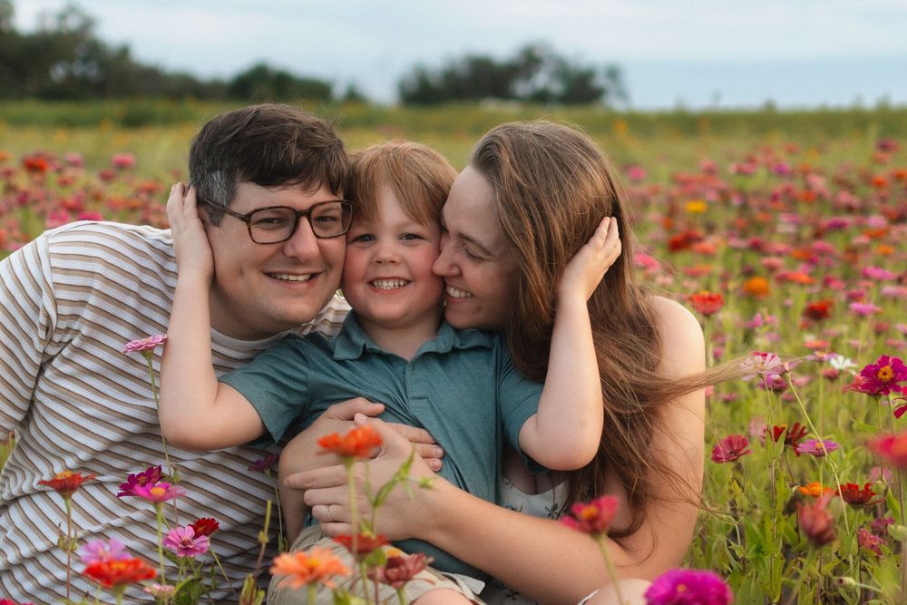 Family walking through flower fields at Fancy Farms Market in Plant City, Florida during a spring family photography session.