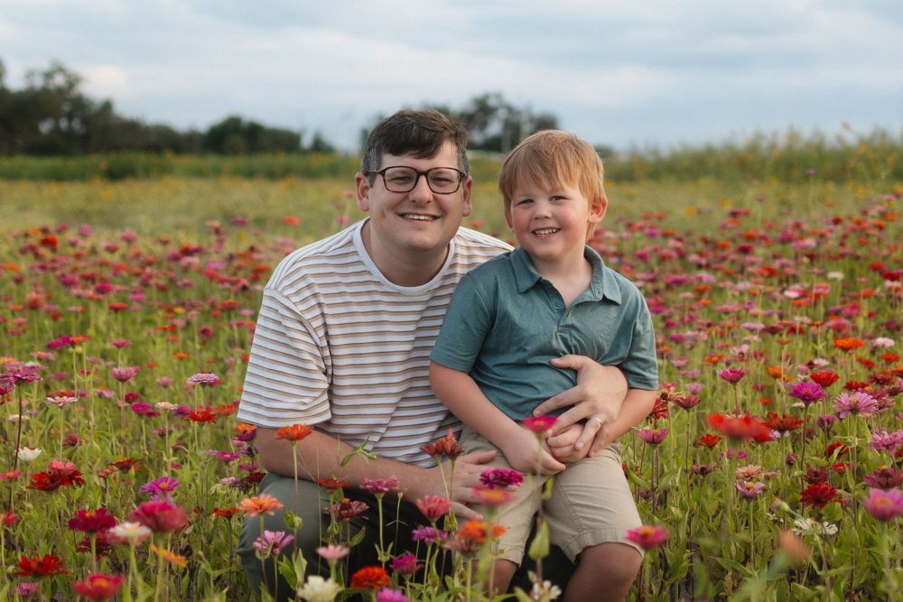 Father and son portrait in flower fields at Fancy Farms Market, Plant City, Florida by a Lakeland family photographer.