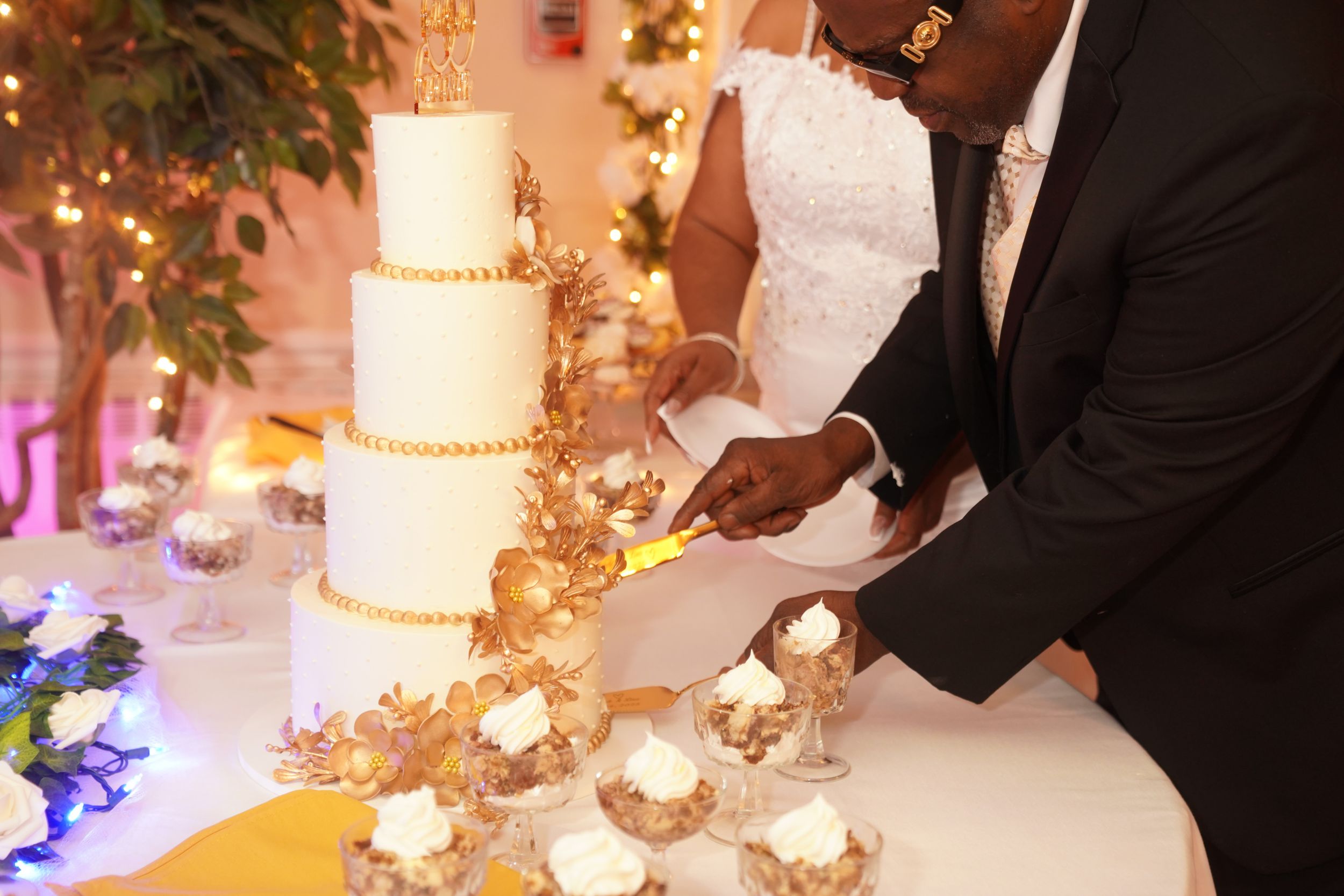 Elegant wedding reception table adorned with white floral centerpieces and glowing candles creating a romantic atmosphere.