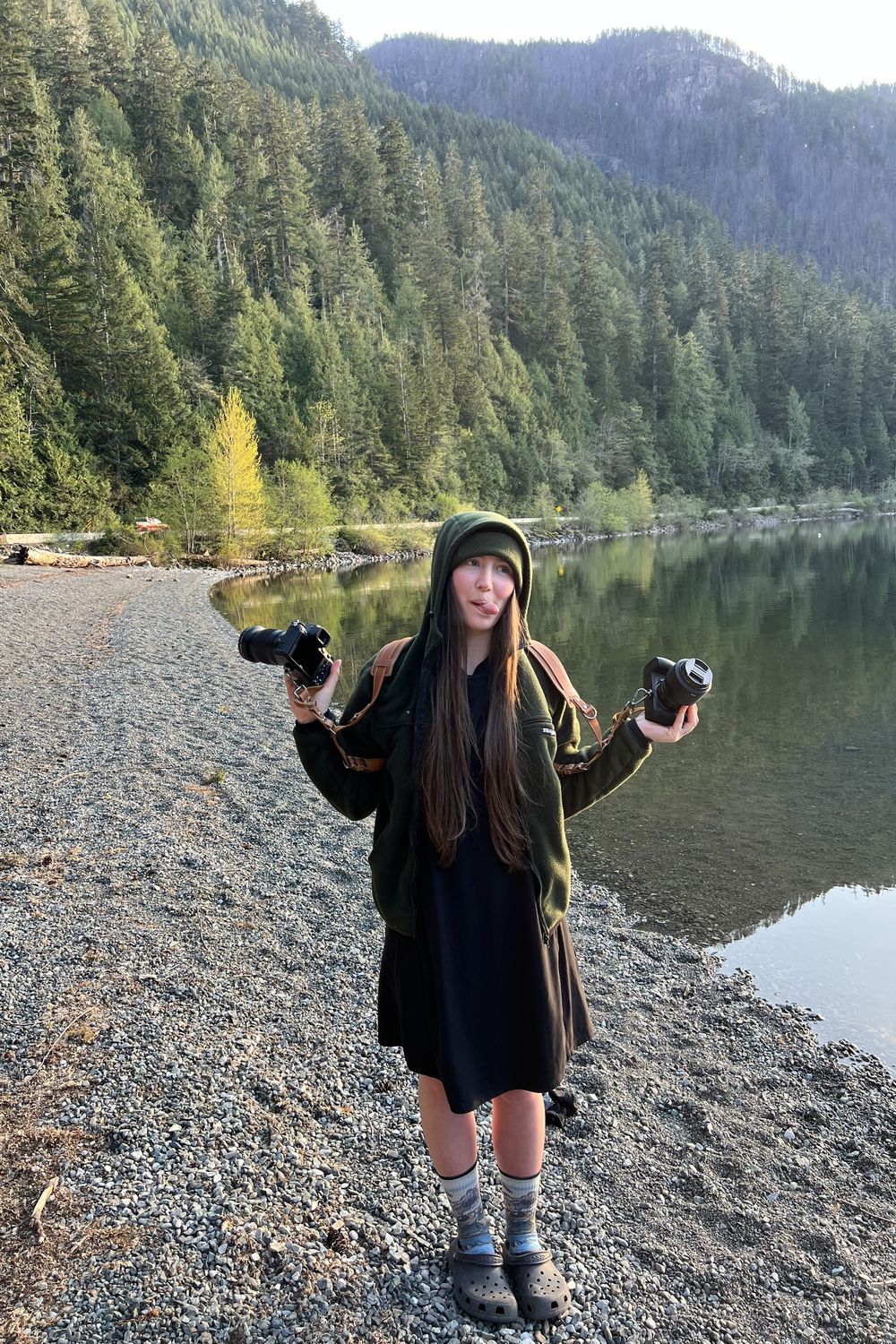 Katie Phillips (Soulfull Photographs) the photographer holding her two camera by Cameron Lake Vancouver Island sticking her tongue out