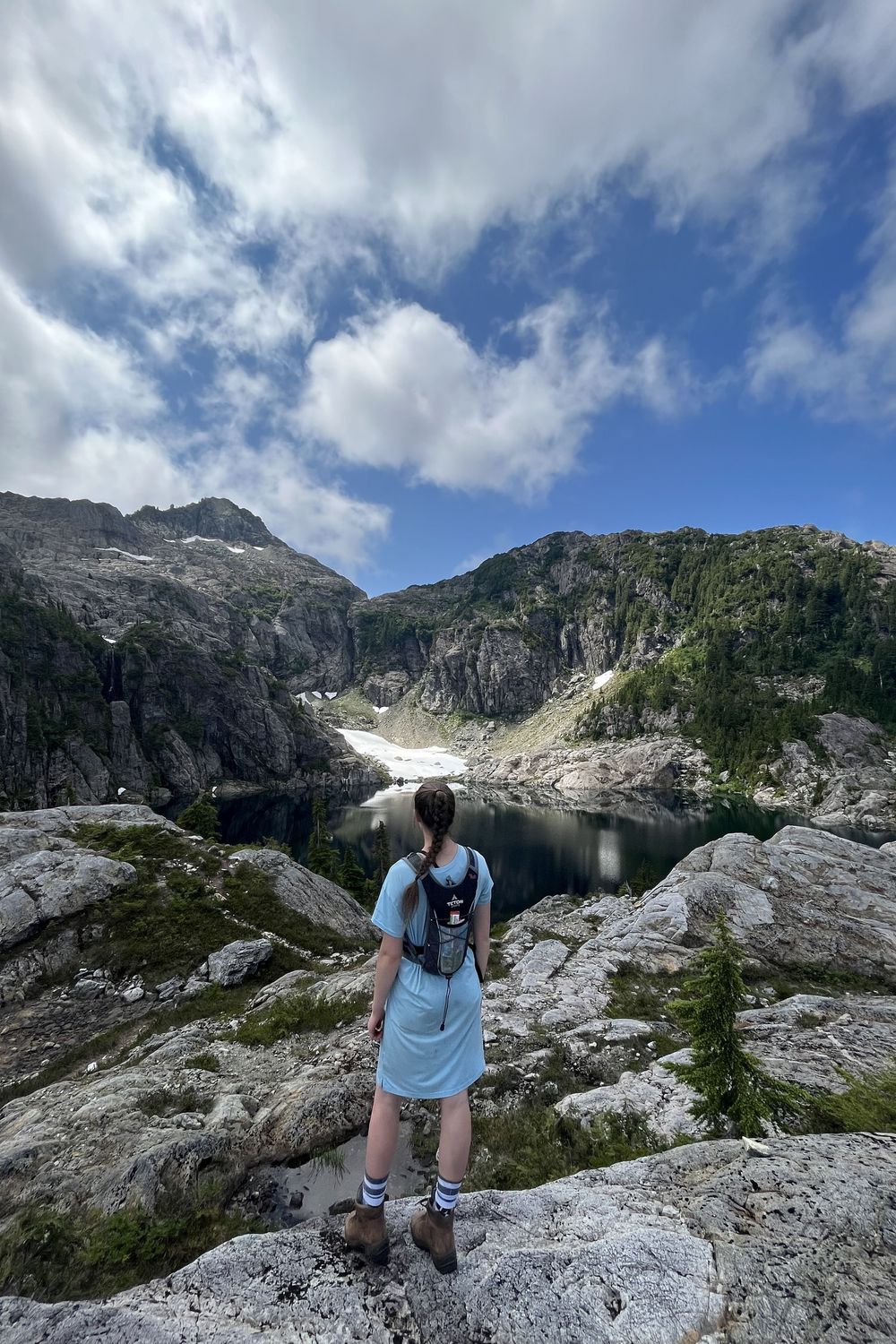 Katie Phillips (Soulfull Photographs) the photographer on Triple Peak by the lake with her backpack Vancouver Island adventure photography