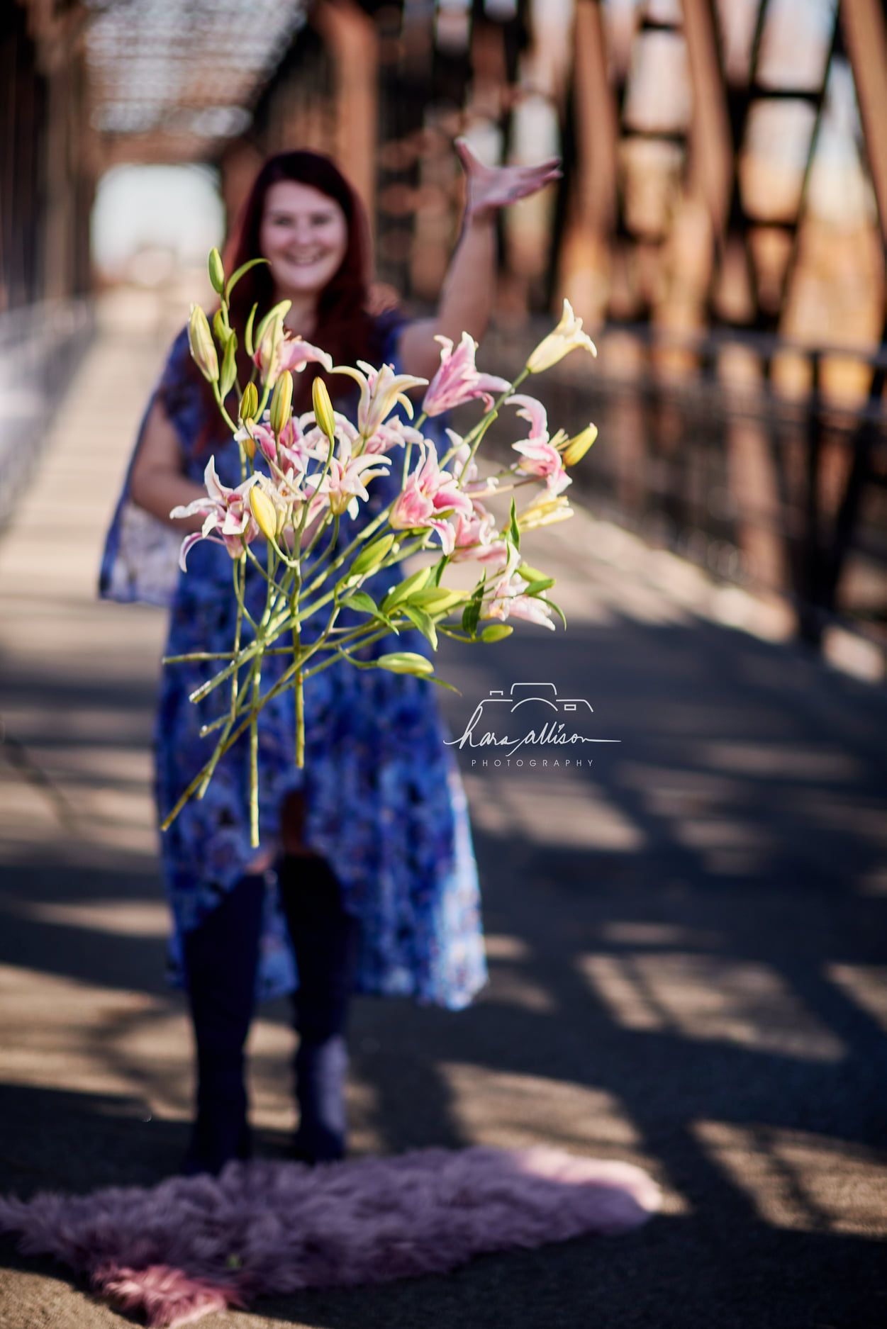Colorful lilies and flowers in soft focus with blurred background on bridge setting.
