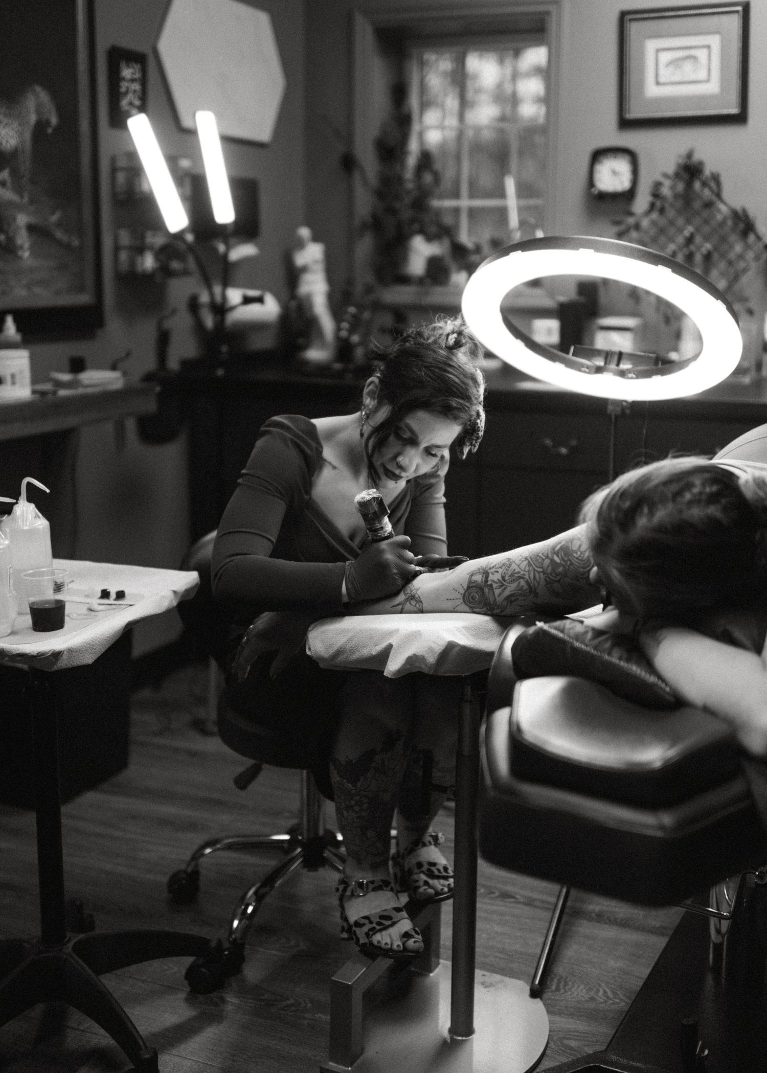Tattoo artist working in a studio during a black and white branding session