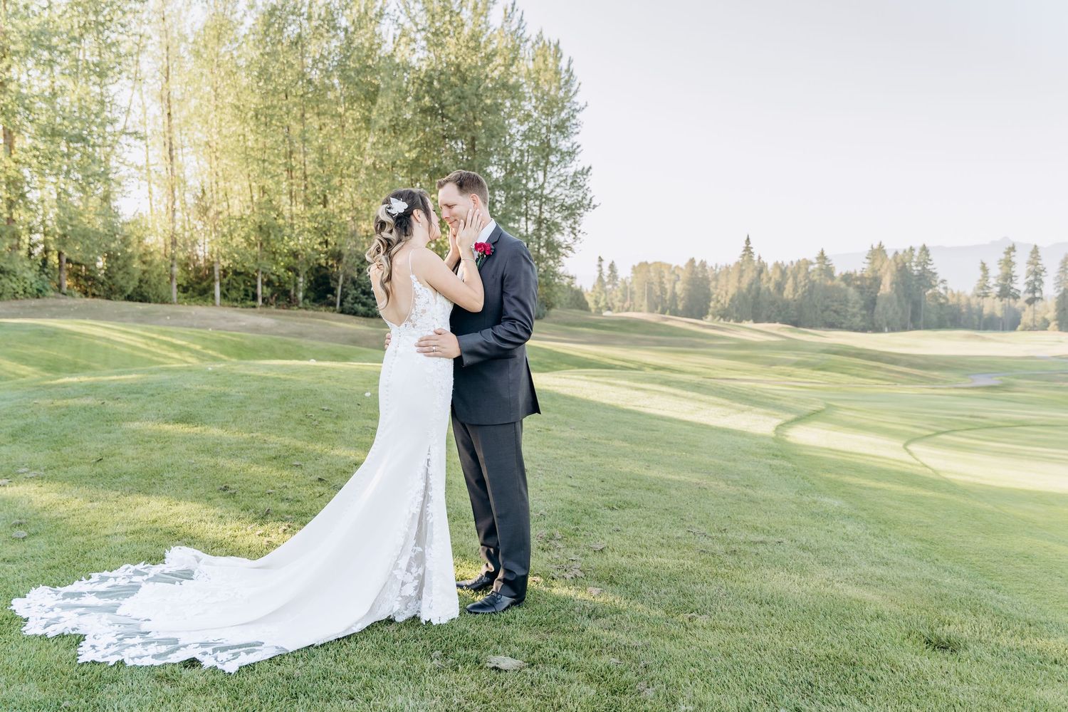 Newlyweds share intimate moments on a scenic golf course during golden hour.