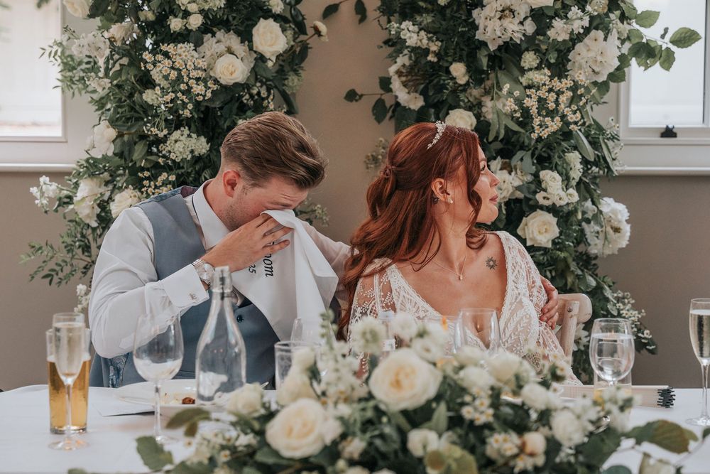 Groom wiping away tears during emotional wedding speech at Rockbeare Manor