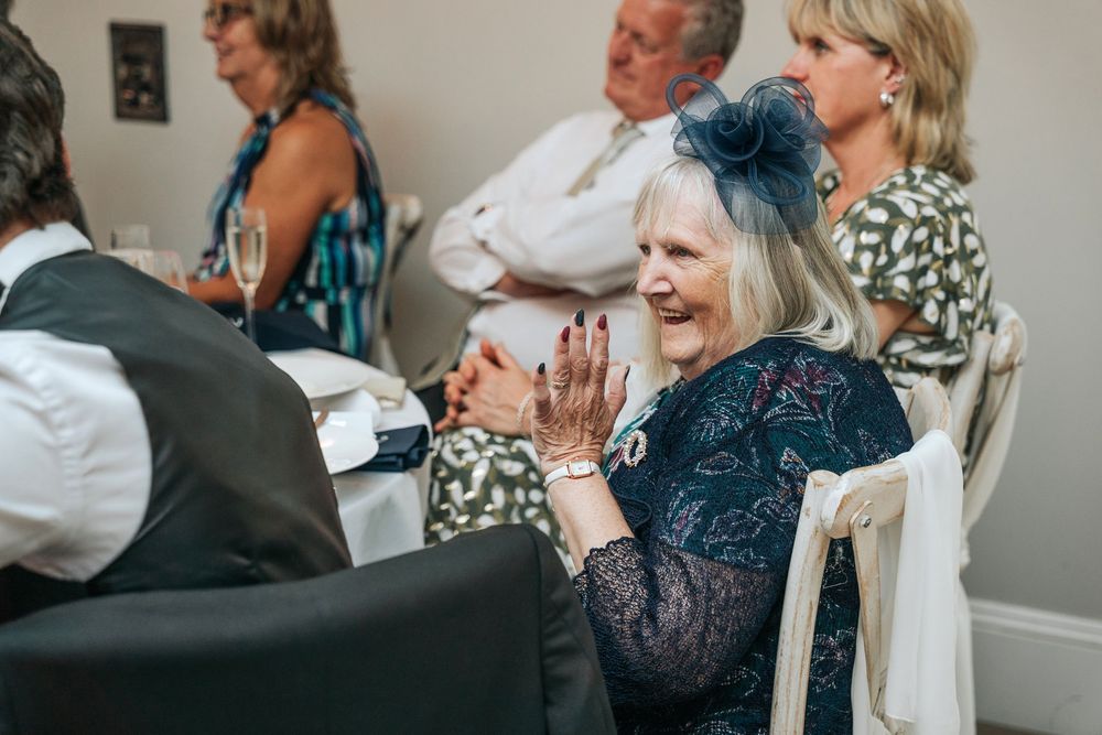 Wedding guests reacting to emotional speeches at Rockbeare Manor