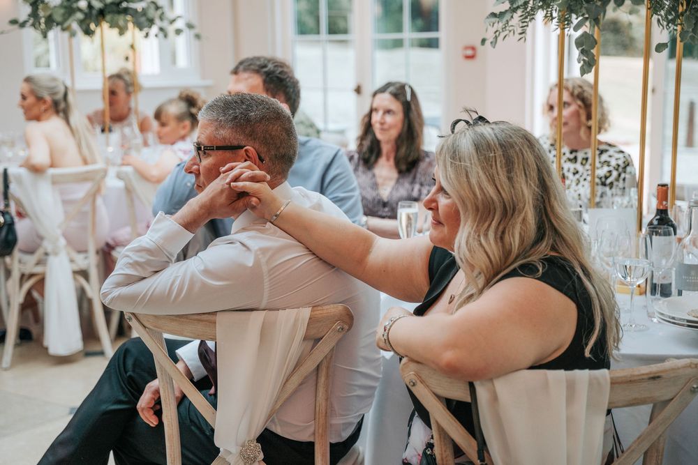 Wedding guests reacting to emotional speeches at Rockbeare Manor