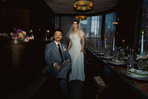 Romantic wedding reception venue with elegant table settings and floral arrangements in dim lighting.