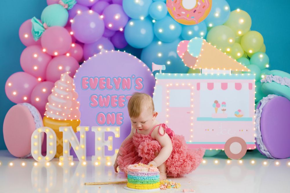 Pastel balloon arch and dessert table setup with pink and blue colors for a first birthday cake smash celebration. northside cake smash phot