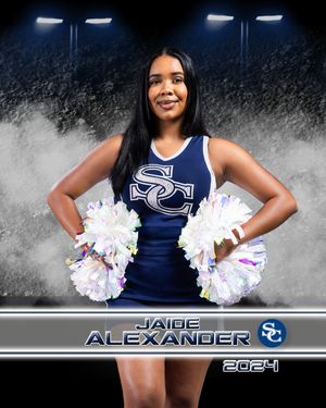 Cheerleader in navy blue uniform holds white pom poms against dramatic smoky background with stadium lighting.