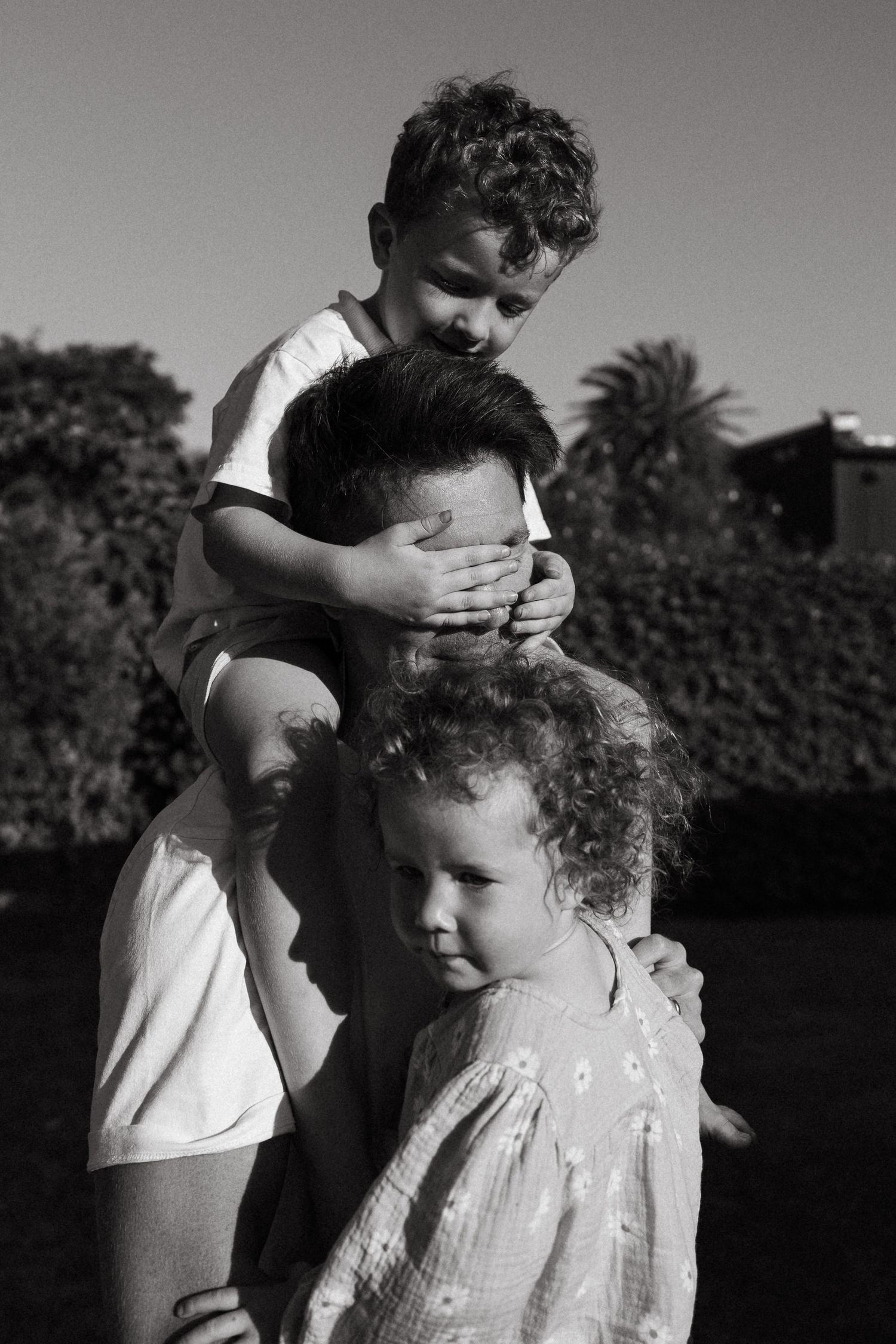 Black and white portrait of children playing outdoors.