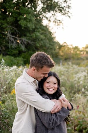 Couples photo session in a wildflower field, capturing romantic and natural moments amidst vibrant blooms.