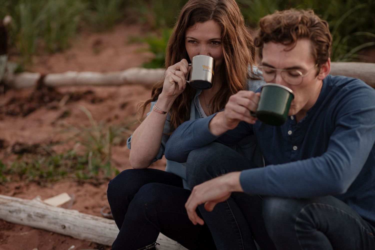 Couple sipping coffee together during a cozy cinematic storytelling photoshoot on the beach with Lumenali Photography. Chelton, PEI, Canada.