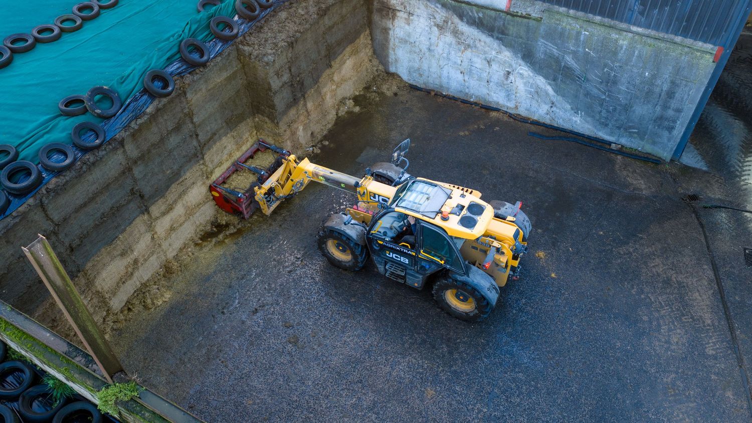 A line of industrial machinery and equipment arranged in a row against a dark background.