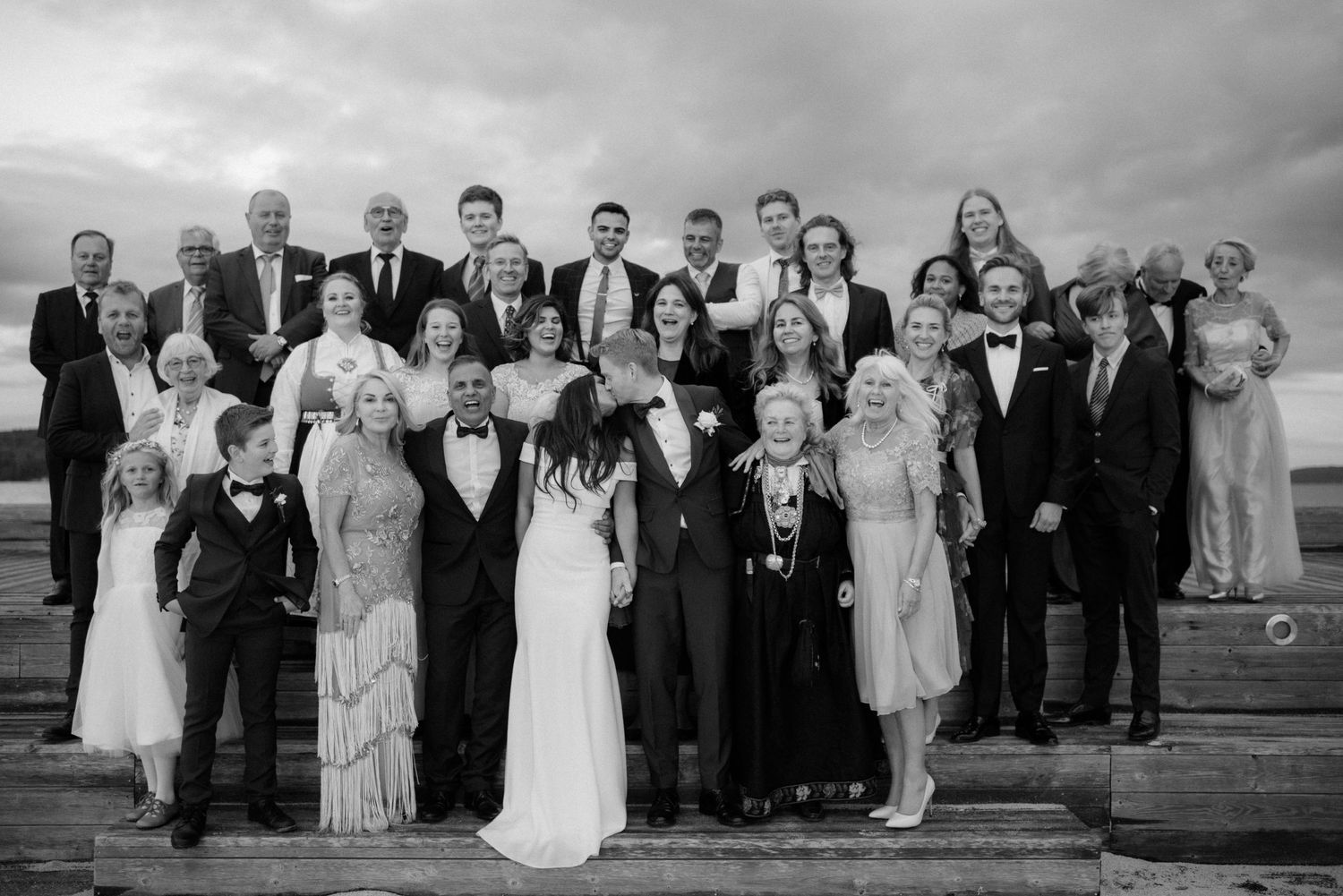 Black and white wedding party formal group photo on steps outdoors with vintage attired guests and bridal couple at Villa Malla in Filtvet.