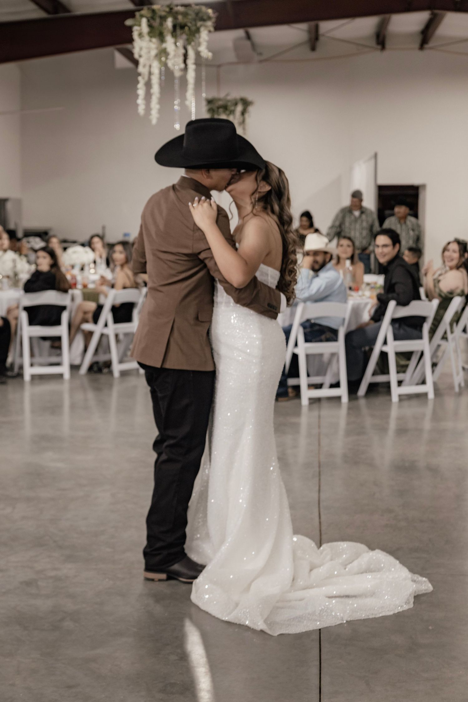 Married couple shares a first dance and kiss on wedding day
