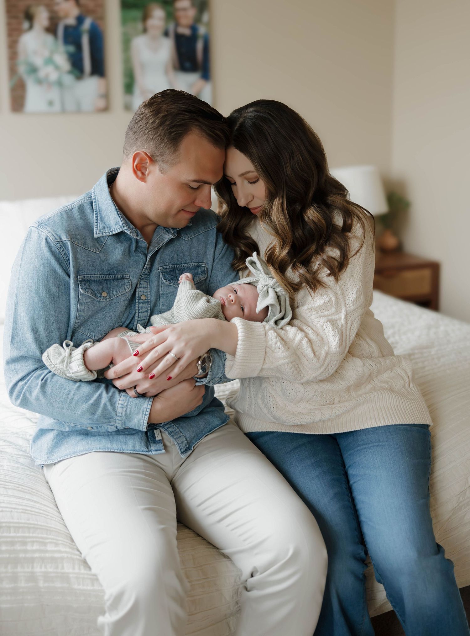 A couple in denim and white sits together on a couch in a series of intimate lifestyle photos.