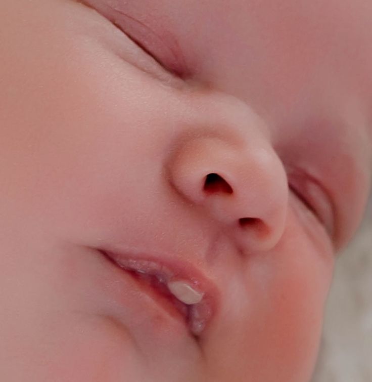 Close-up macro shots of a baby's delicate facial features showing nose, lips, and skin details.