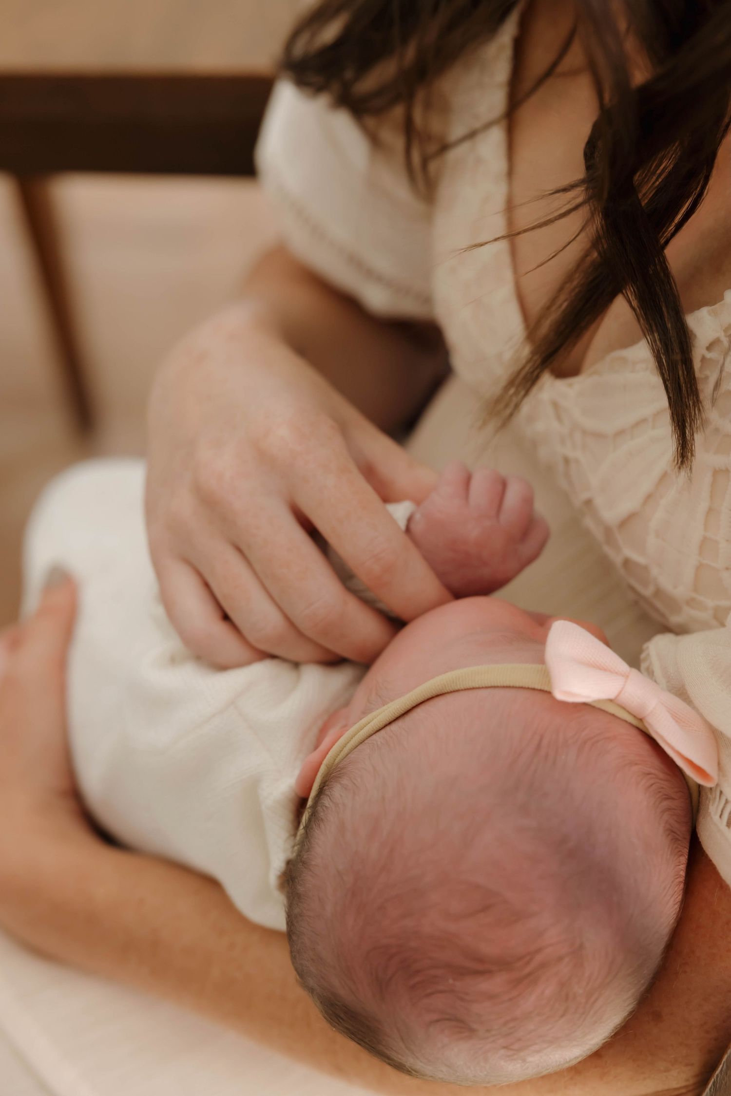 Close-up sequence showing hands kneading and shaping a round ball of bread dough on a light surface.
