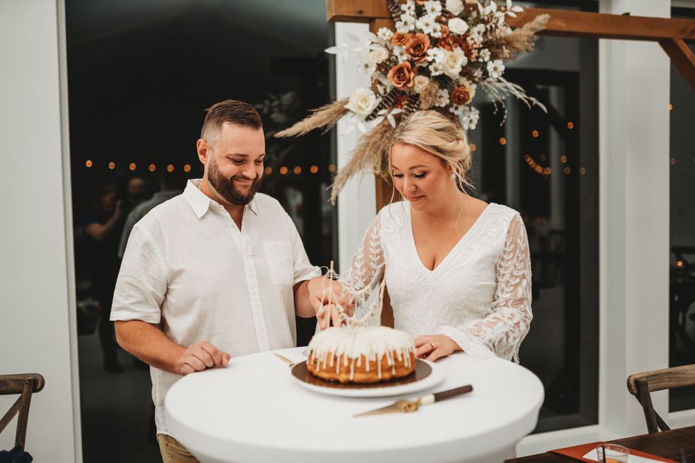 Happy couple sharing their wedding cake during the reception celebration.