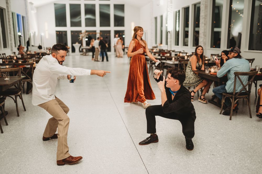 Wedding guests perform fun dance moves on the reception floor.