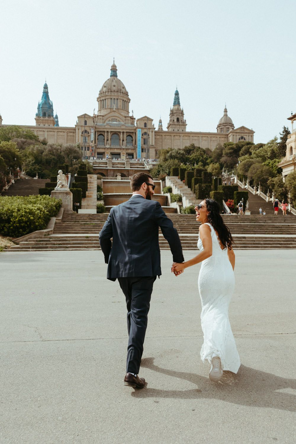 Couple poses on steps leading to Barcelona's National Museum of Art.