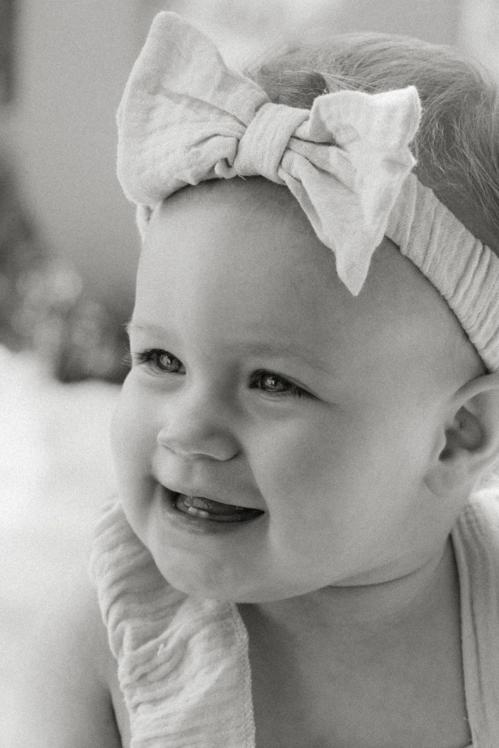 Candid photo of a one-year-old girl exploring outside during her first birthday portrait session.