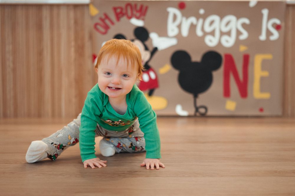 One year milestone photo session in Brookings, SD with a Mickey Mouse theme.