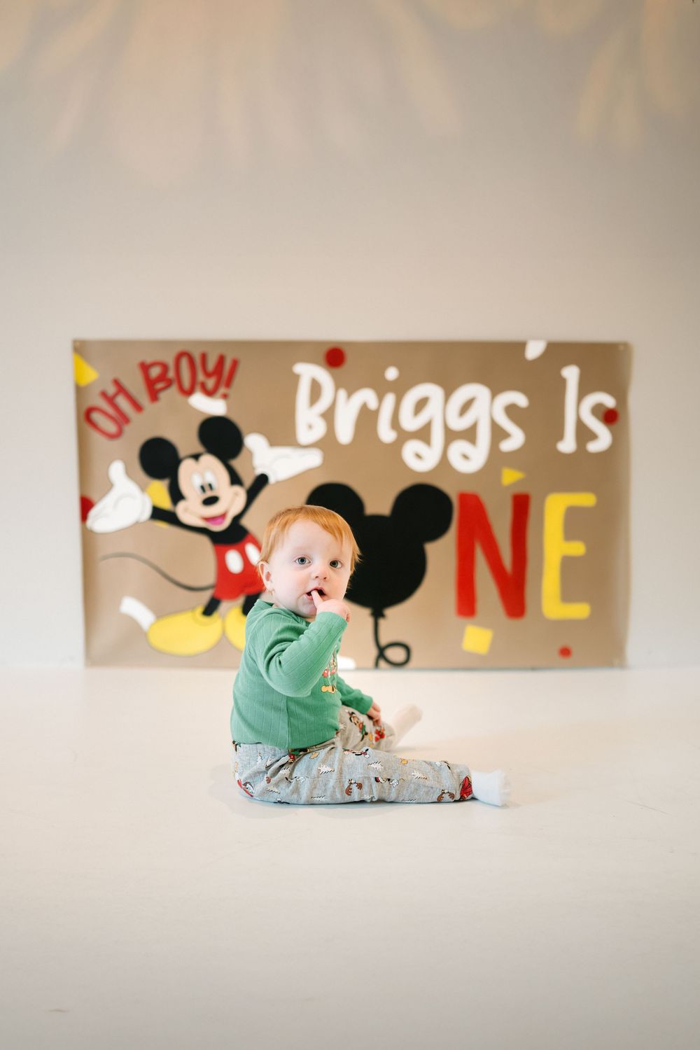 Mickey Mouse first birthday photo session with a little boy and ONE backdrop.