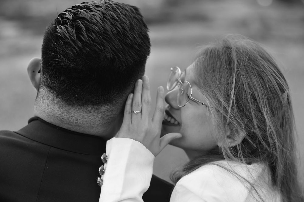 Black and white intimate close-up of couple sharing a tender romantic moment.