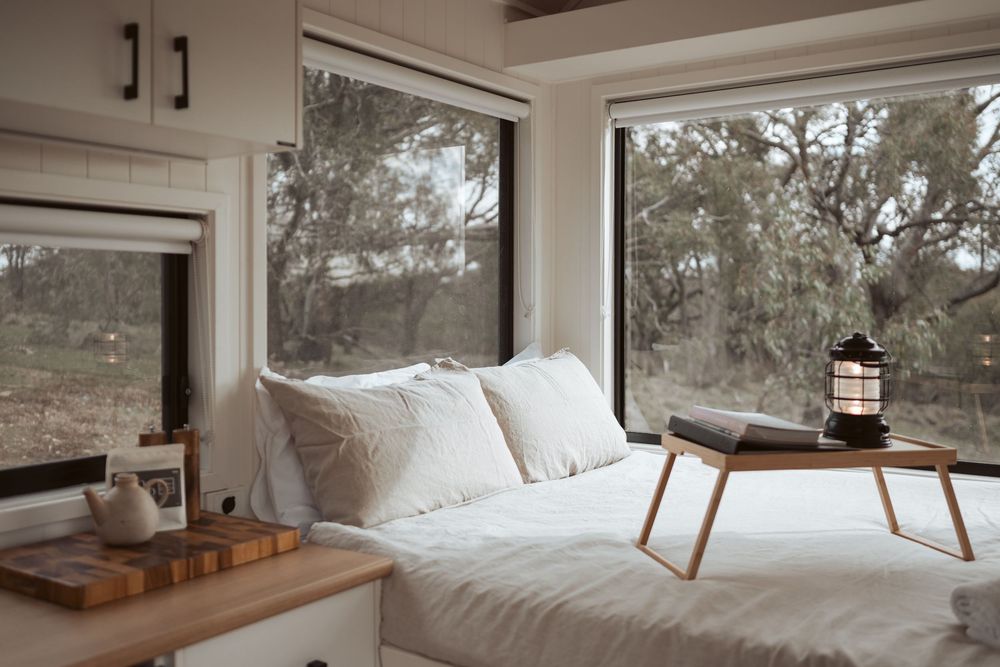 Interior tiny home photography capturing cosy accommodation styling and natural bushland surroundings