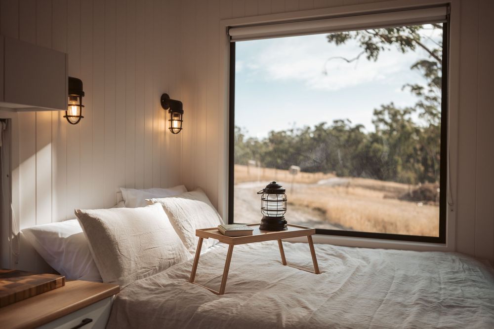 Interior tiny home photography showcasing natural light, bushland views and boutique accommodation styling