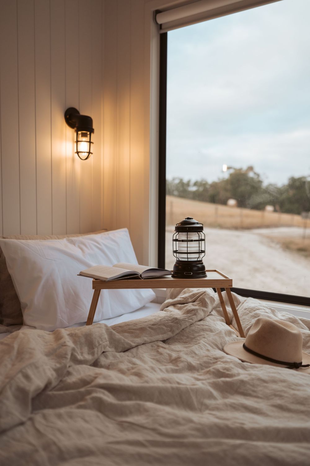 Boutique accommodation interior photography showcasing cosy off-grid cabin styling and natural bushland views