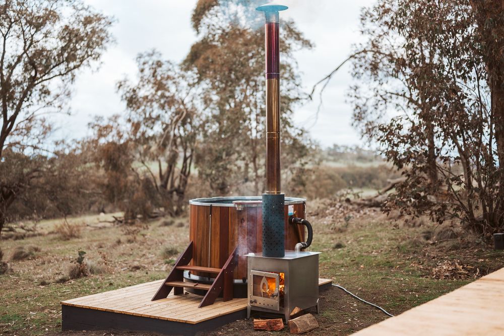 Off-grid tiny home photography capturing outdoor bath experience and remote nature escape in Victoria