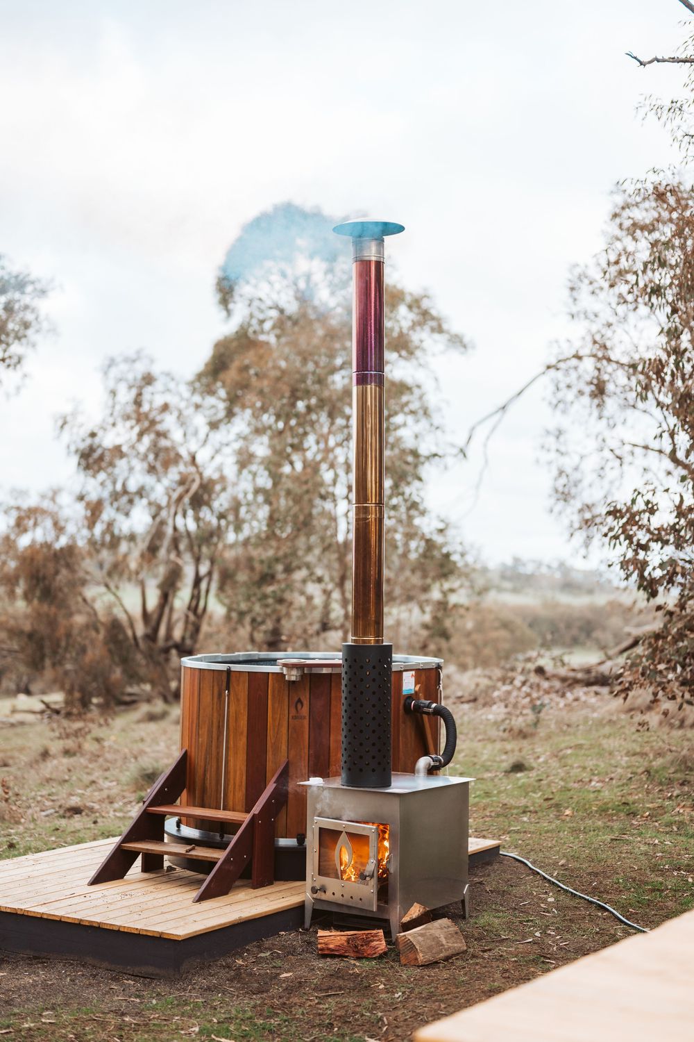 Off-grid accommodation photography showcasing outdoor hot tub and remote nature escape in Victoria