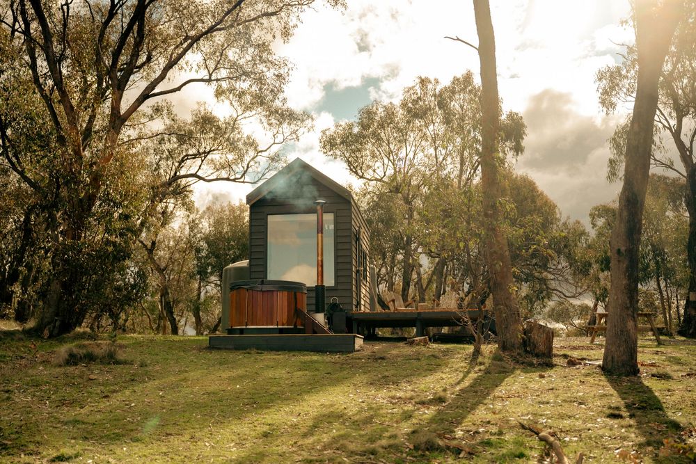Off-grid tiny home photography featuring outdoor bath, bushland surroundings and luxury regional accommodation