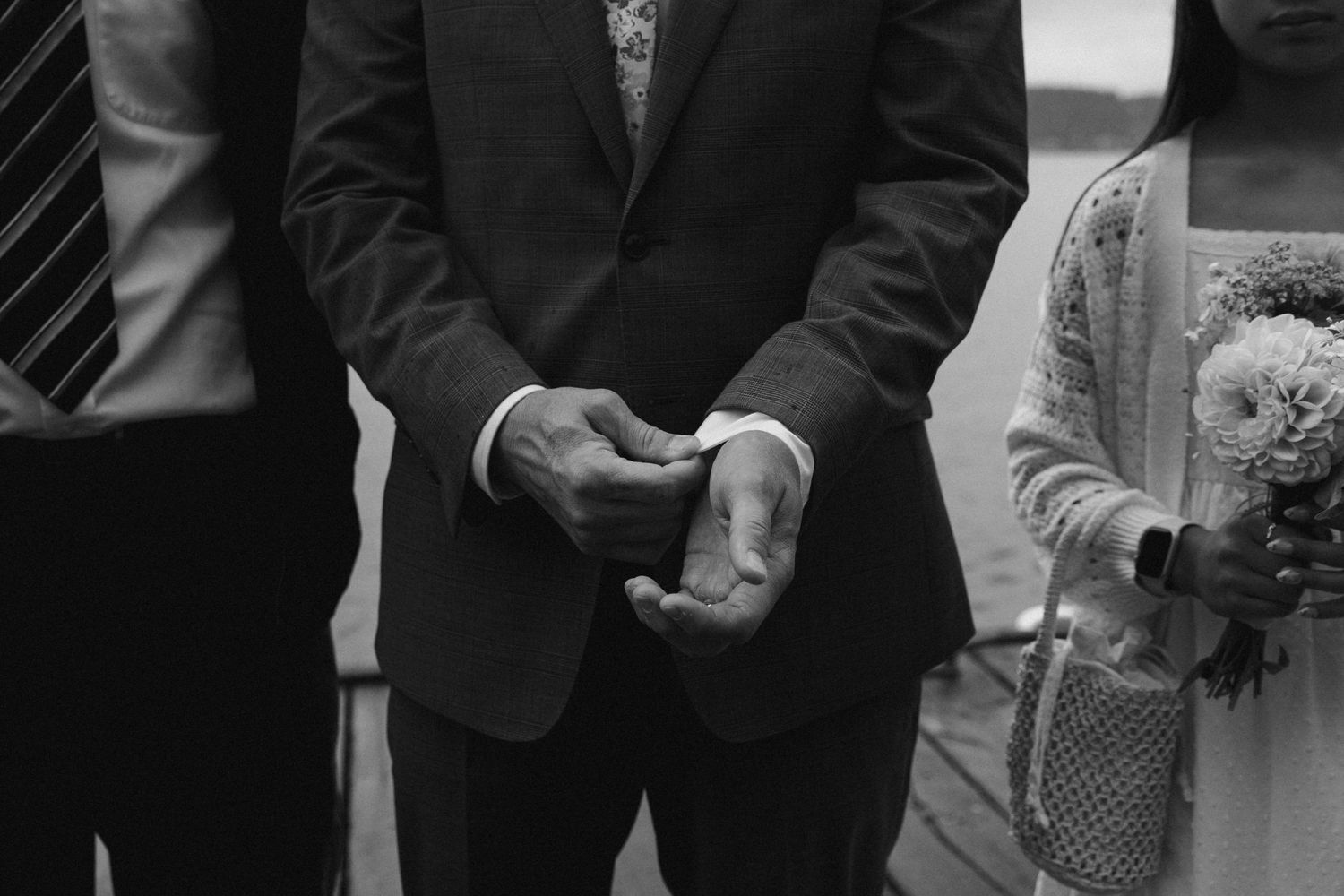 Black and white wedding photo of groom clasping cuff near Seattle Washington
