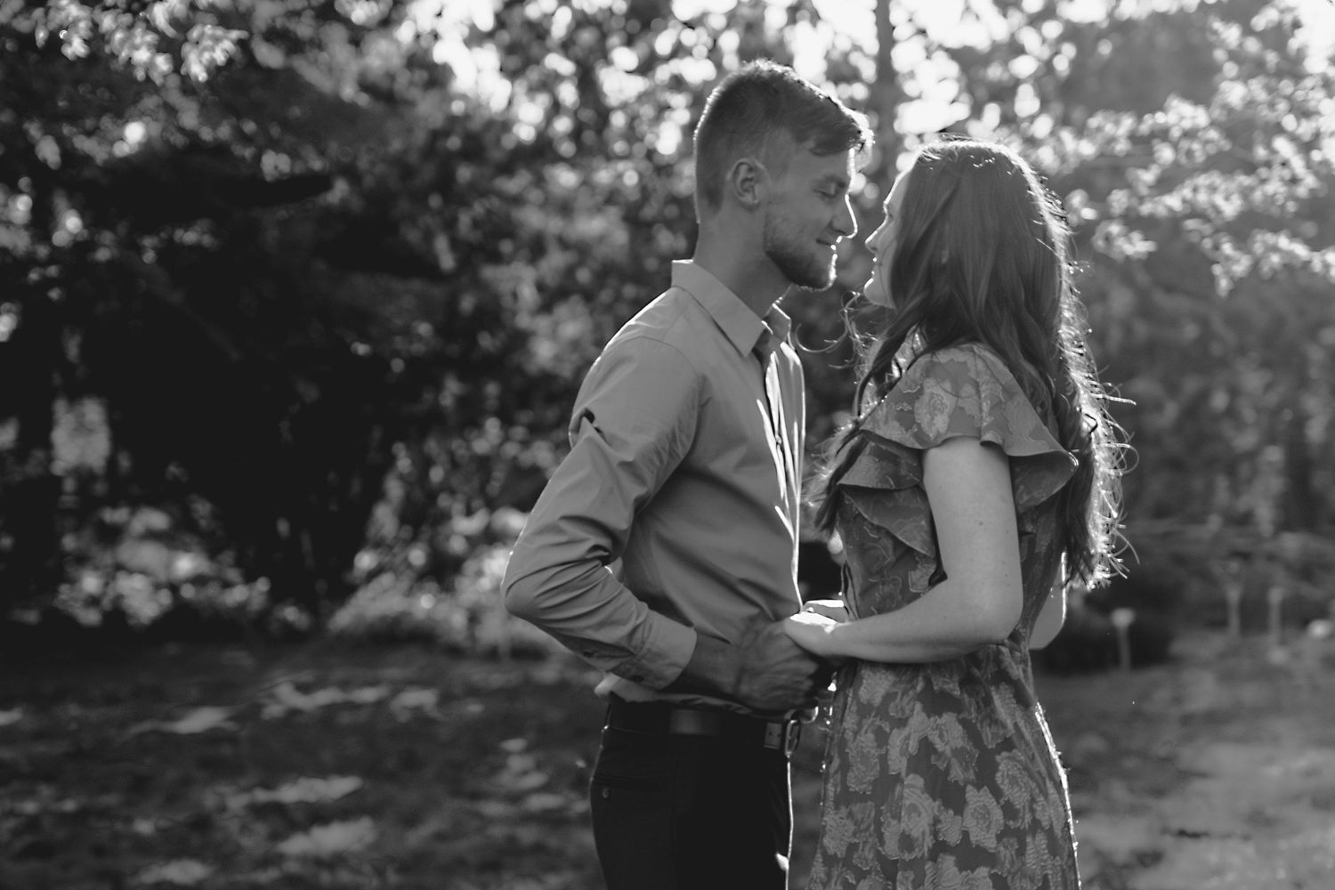 Black and white photographic series showing a couple outdoors in a romantic moment during golden hour.