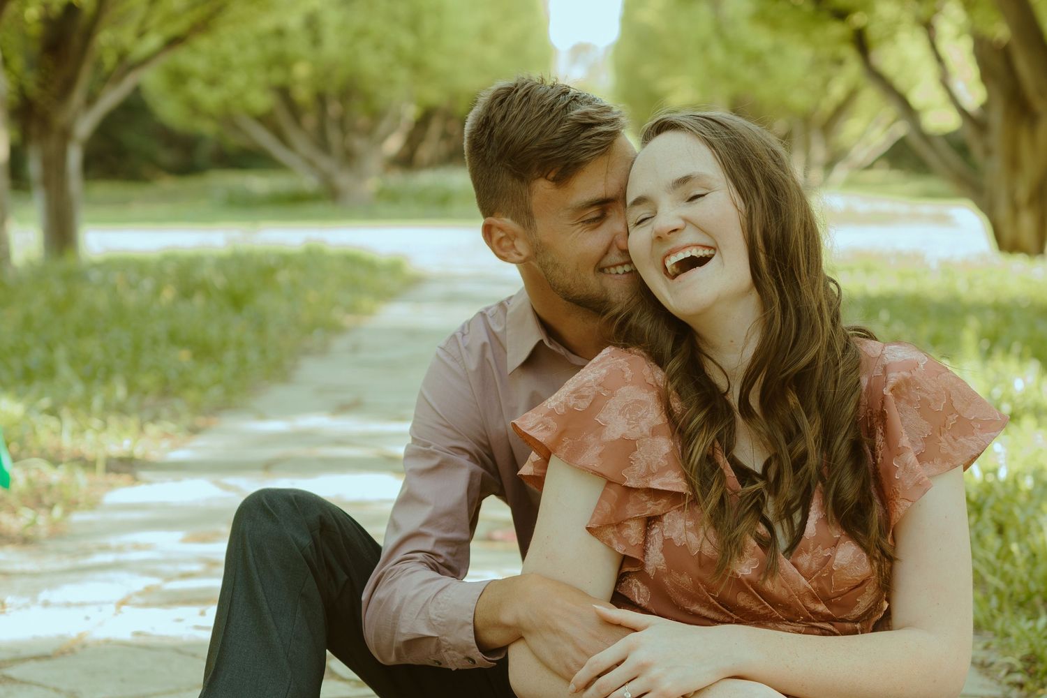 Couple sharing intimate moments during outdoor golden hour photoshoot.