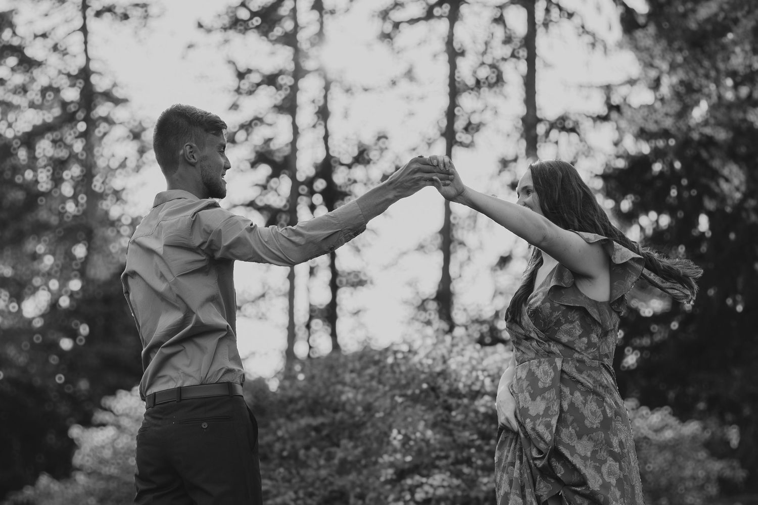 A series of black and white dance movement photographs showing a person performing expressive motions in a wooded setting.