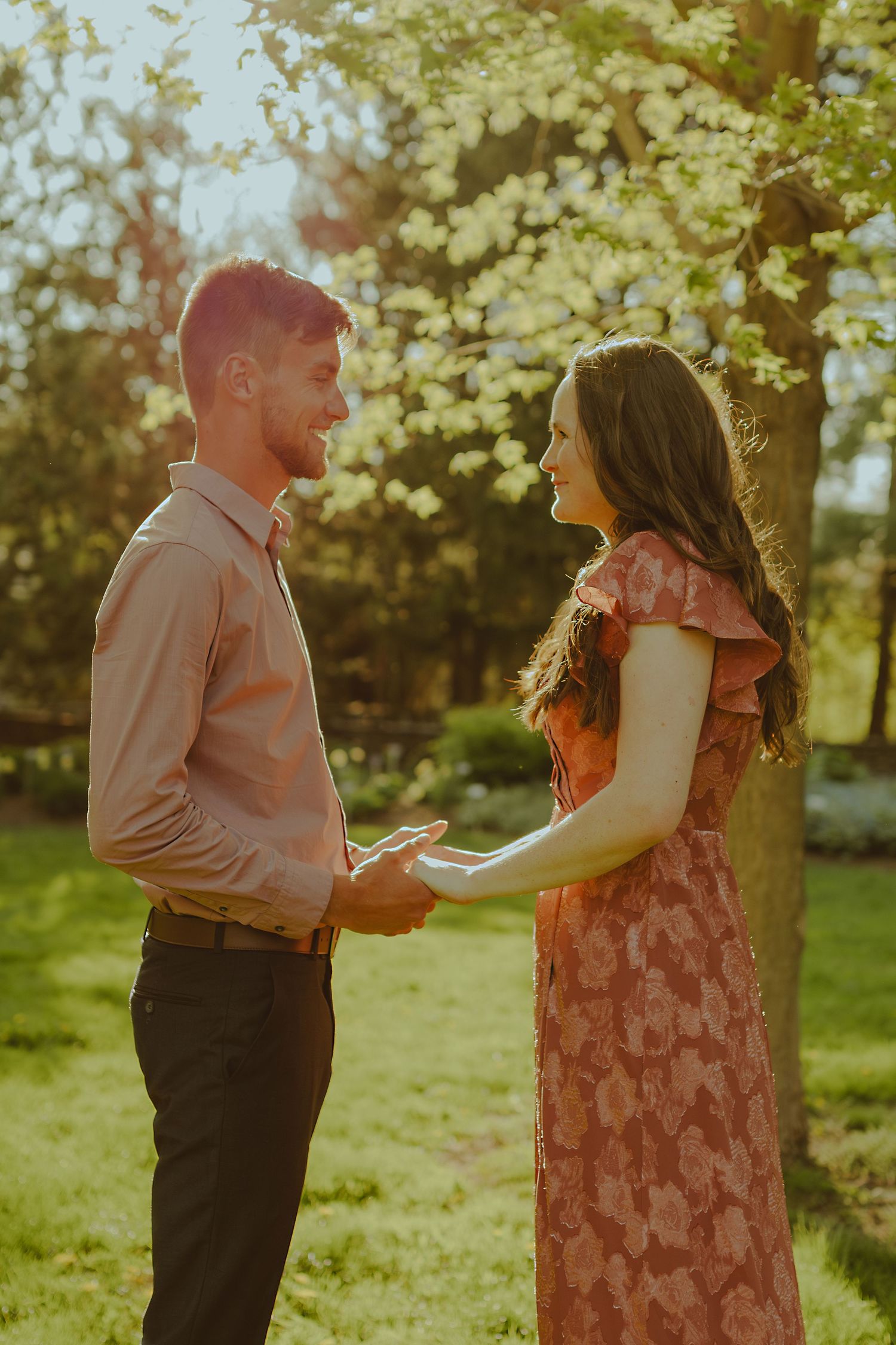 A romantic photoshoot sequence showing a couple dancing together in a sun-drenched garden setting.