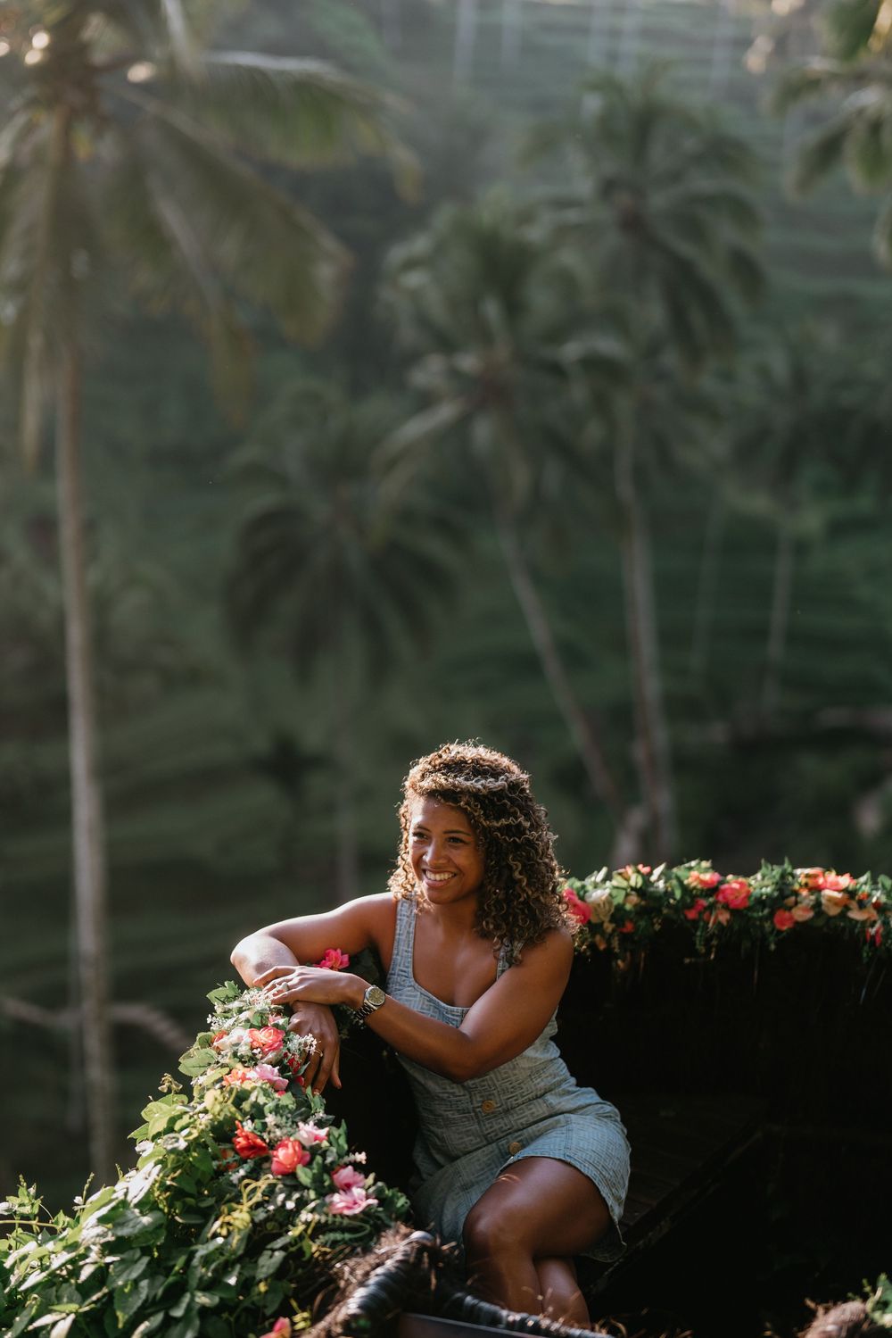 Joyful moment shared between people near tropical flowers and palm trees.