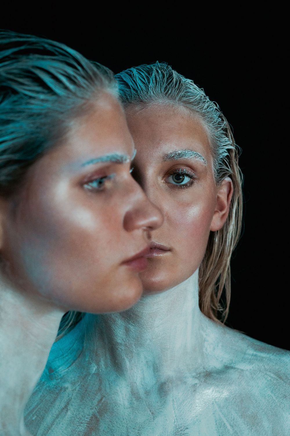 Ethereal portraits with turquoise lighting and condensation effects creating dreamy atmosphere.