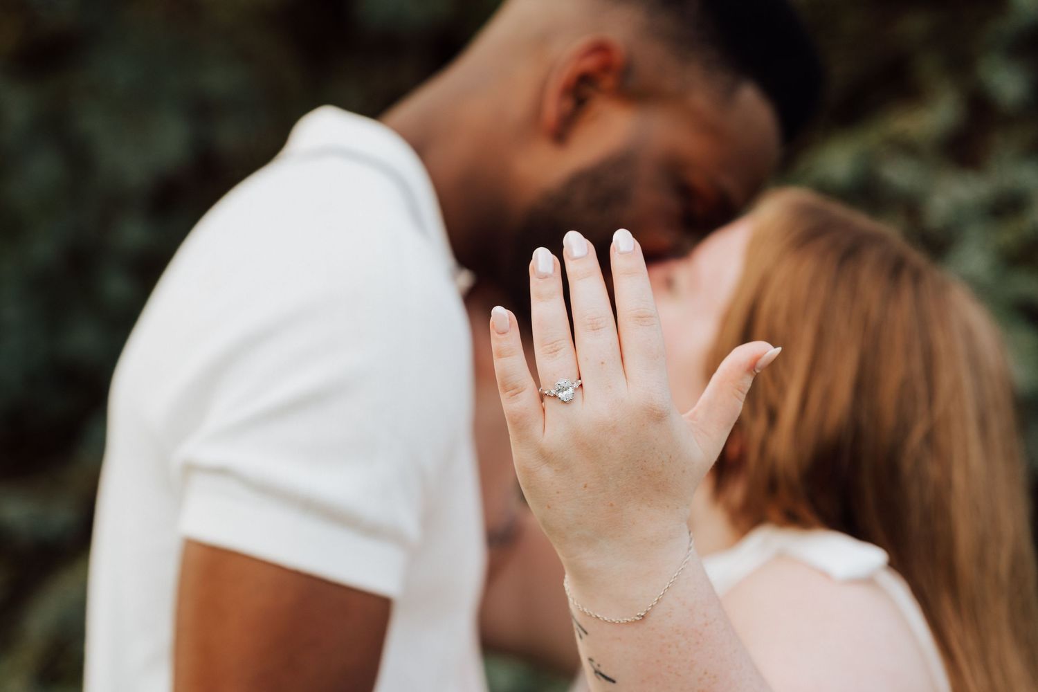 Couple kissing and showing engagement ring for Engagement Photoshoot at Waltz Vineyards Estate Winery in Manheim, PA