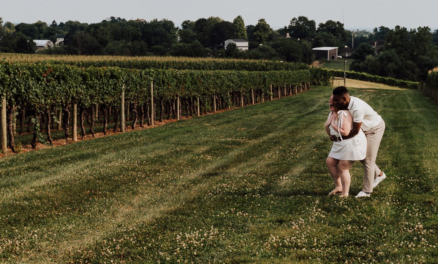 Couple playing joyfully for Engagement Photoshoot at Waltz Vineyards Estate Winery in Manheim, PA