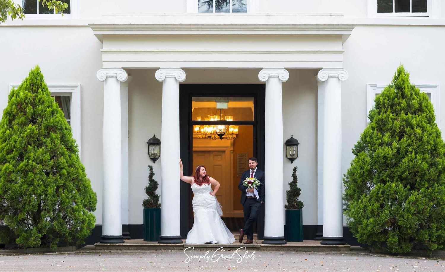 A bride and groom pose in a styled photograph captured by an Eastwood hall wedding photographer