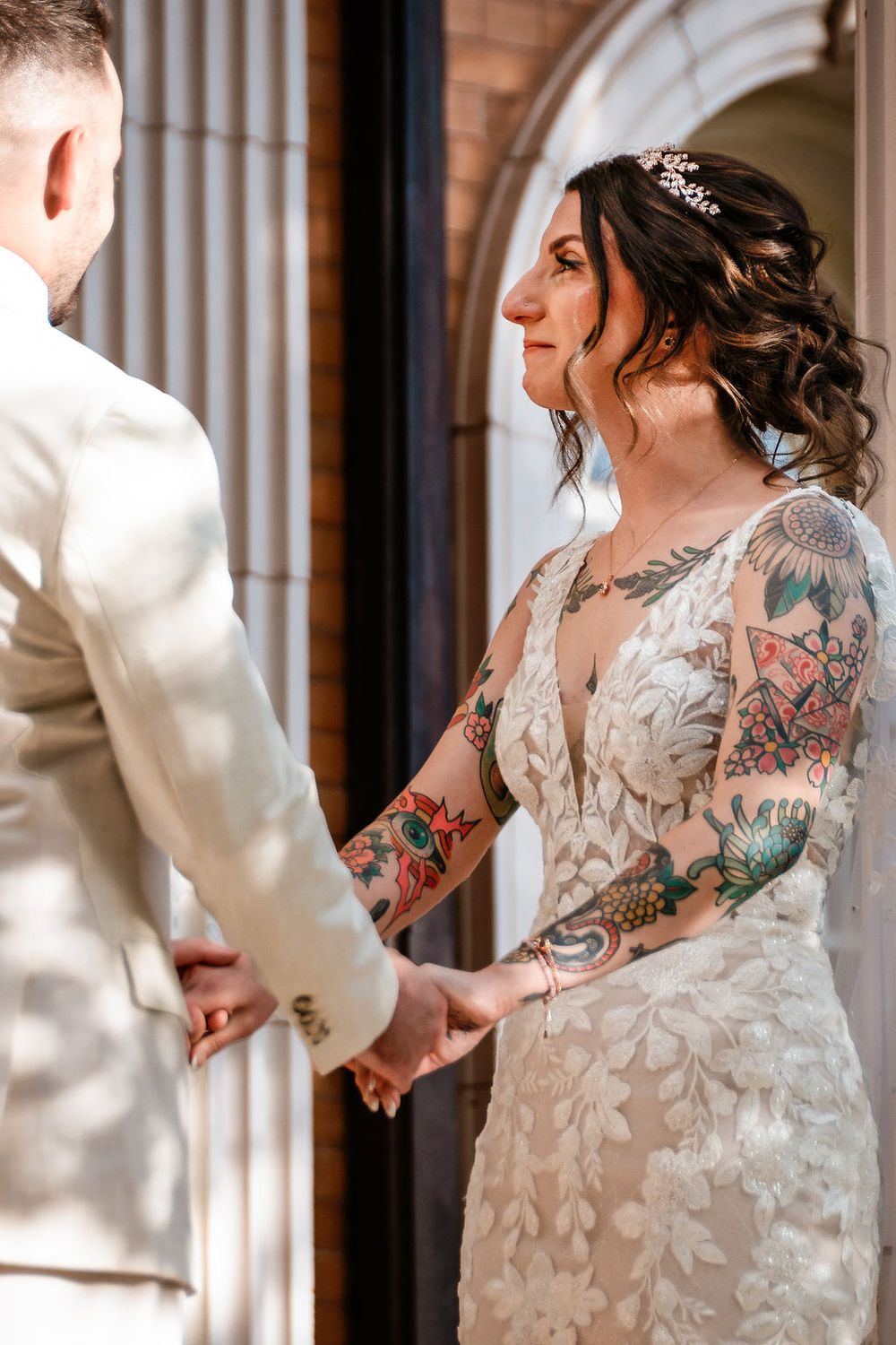 bride holding husbands hands at the grant Humphreys mansion altar while a tear runs down her cheek.